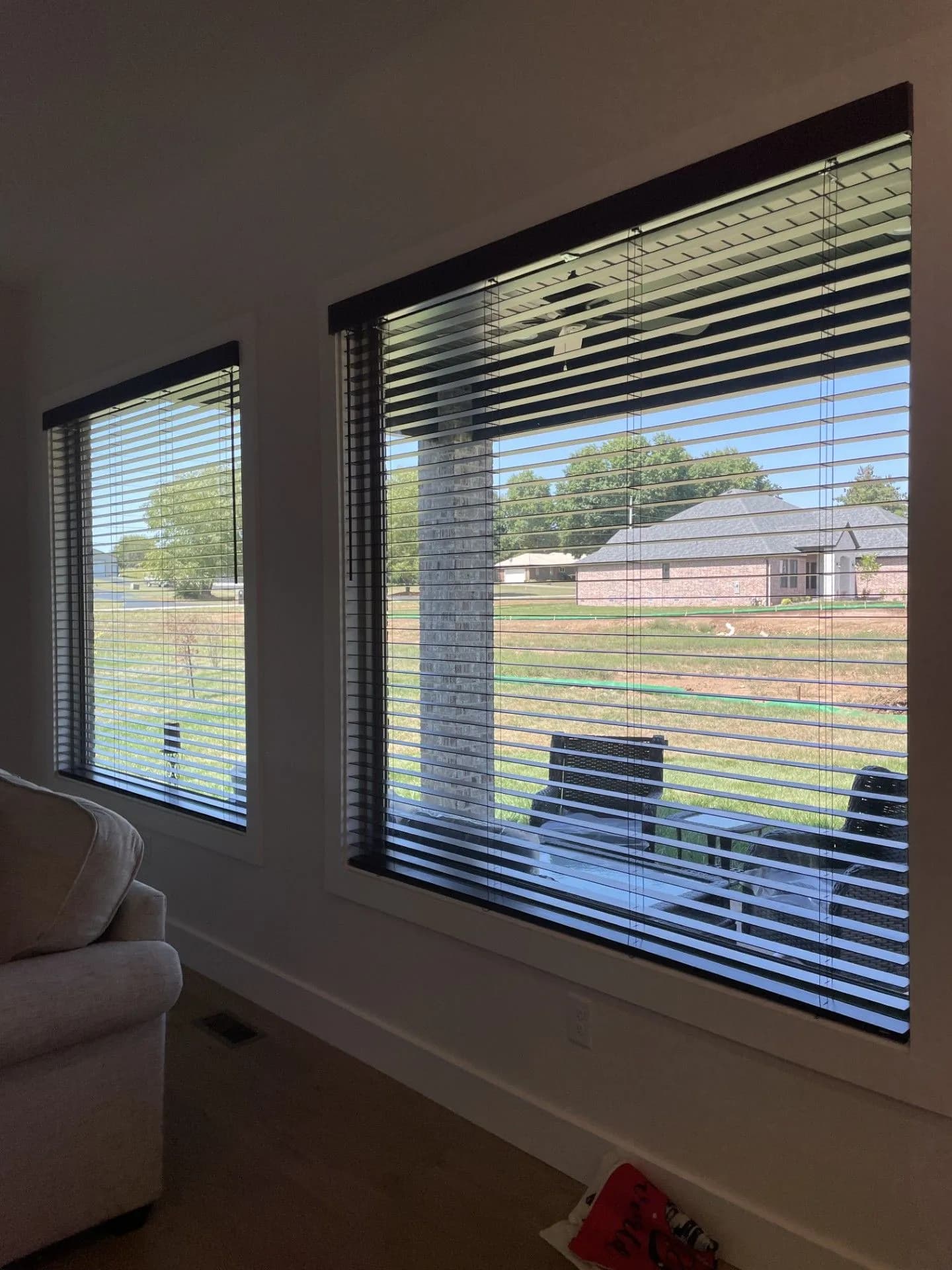 Custom wood blinds open on two windows